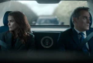 "Two serious people in formal attire sit in the back of a car with a presidential seal, looking out the windows; the environment is tense, with another vehicle visible behind them through the rear window."